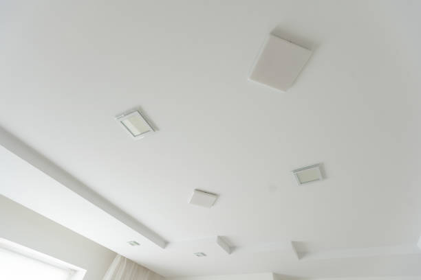 istock suspended ceiling with halogen spots lamps and drywall construction in empty room in apartment or house. Stretch ceiling white and complex shape. 1929739890