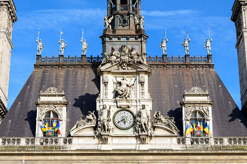 This landscape photo was taken, in Europe, in France, in ile de France, in Paris, on the banks of the Seine, in summer. We see the town hall, under the sun.