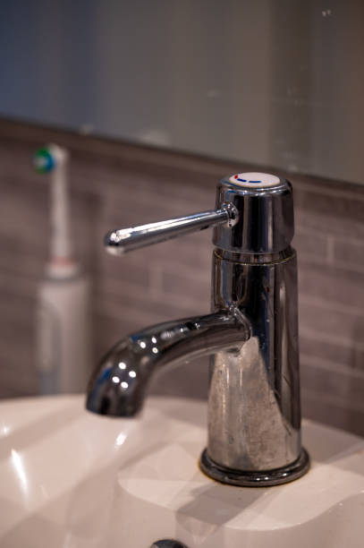 istock Water tap and electric toothbrush in bathroom 1929757231