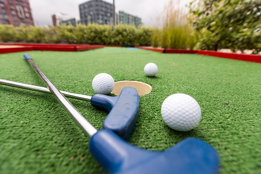 Close up, Old golf balls and putter on artificial grass for practice. High quality photo