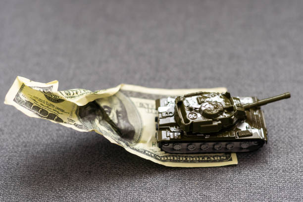 istock toy tank and dollars, army token 1929761521
