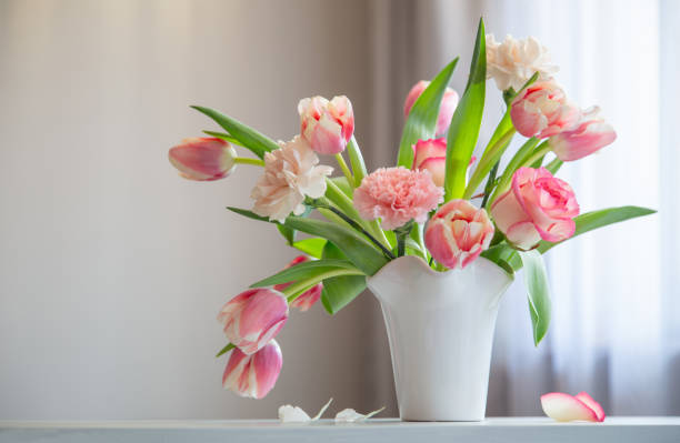 istock pink spring flowers in white ceramic vase in modern home interior 1929777921