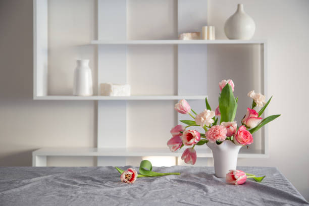 istock pink spring flowers in white ceramic vase in modern home interior 1929777925