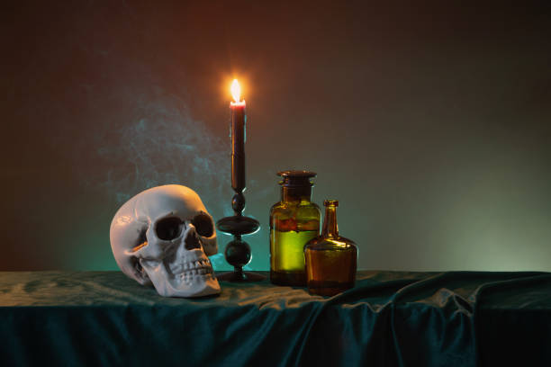 scull and burning candles with halloween decor on dark background