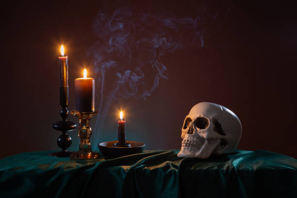 istock scull and burning candles with halloween decor on dark background 1929778446