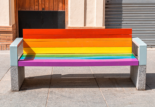 Rainbow colors bench symbolizing gay pride and human rights. Lgbt community. All people are equals. Lgbt flag. Love is love. Freedom and power protest.