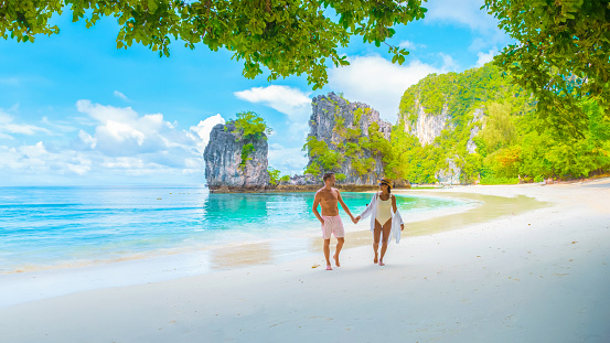 Koh Hong Island Krabi Thailand, a couple of men and women on the beach of Koh Hong during vacation in Thailand, a tropical white beach with Asian women and European men in Krabi Thailand