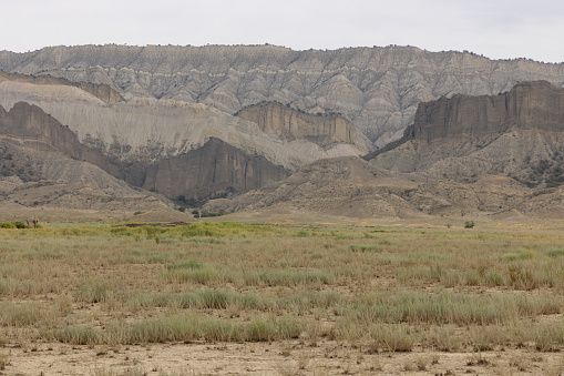 Landscape of Vashlovani national park of caucasus mountains in Georgia. Semi-desert panoramic view of dry grasslands with mud mountains and shrubs