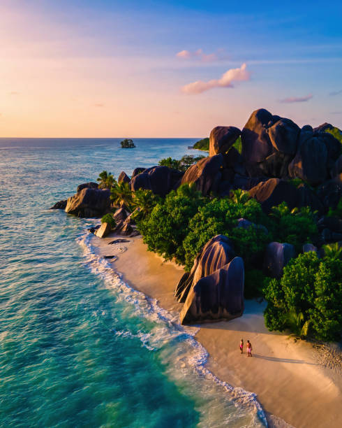 istock Anse Source d'Argent beach, La Digue Island, Seyshelles, Drone aerial view of La Digue Seychelles bird eye view, couple men and woman walking at the beach during sunset at a luxury vacation 1929812058