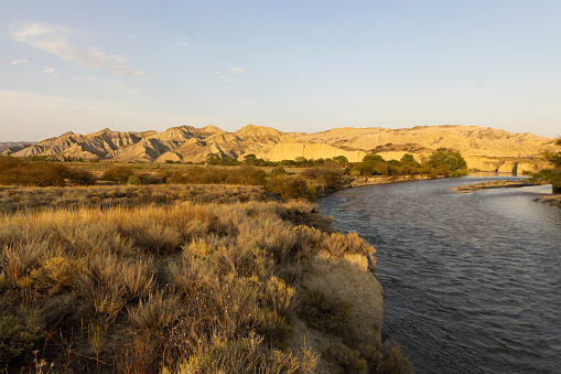 Landscape of Vashlovani national park in Georgia with cliffs and Alazani river in desert scenery at sunset