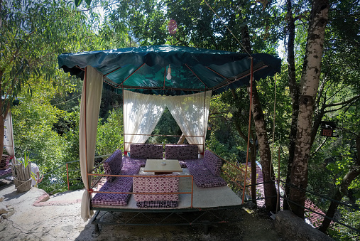 Open place to dine with pillow, curtains, wooden shed made of bamboo in the wild forest