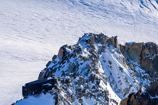 Ice axe and climbing helmet on top of mountain