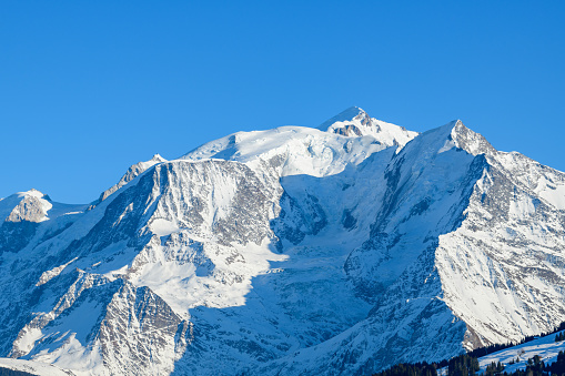 This landscape photo was taken in Europe, in France, Rhone Alpes, in Savoie, in the Alps, in winter. We see the Mont Blanc massif, under the Sun.