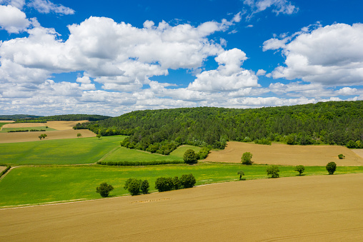 This landscape photo was taken in Europe, in France, in Burgundy, in Nievre, near Chateau Chinon, in summer. We see the countryside with its forests and green fields, under the Sun.