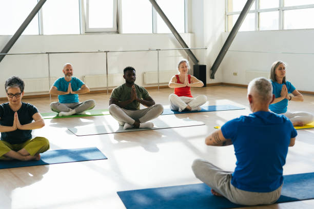 istock Group of senior athletes raise hands to ceiling at workout 1929853142