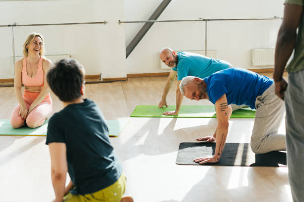 istock Group of senior athletes raise hands to ceiling at workout 1929853171