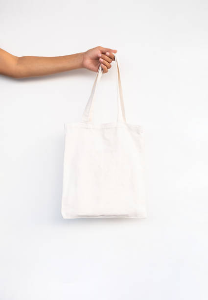 istock Females hand holding reusable textile shopping bag. 1929858553