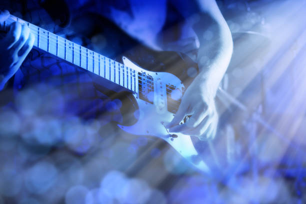 istock Close up blurred motion playing electric guitar in blue light 1929862298