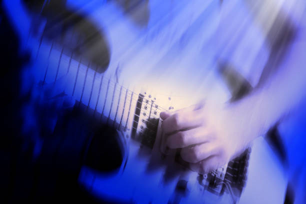 istock Close up blurred motion playing electric guitar in blue light 1929862305