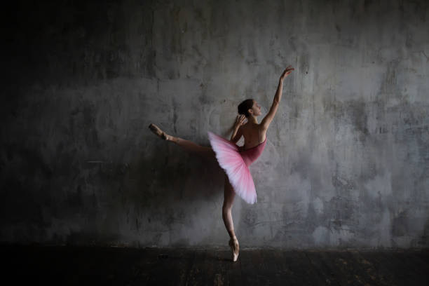 istock Ballerina in a tutu in a ballet pose. 1929878788