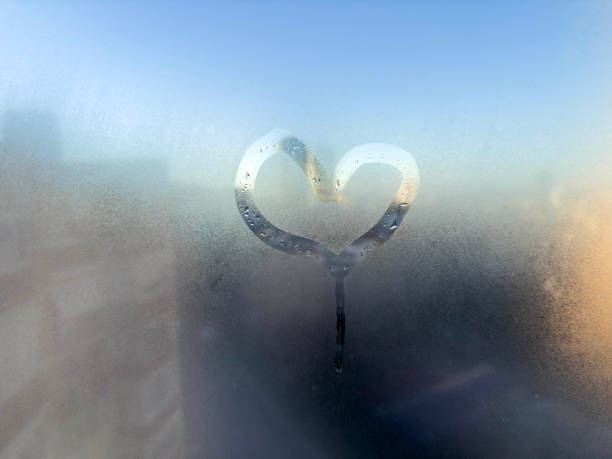 istock hand drawn heart shape on steamed window glass 1929881797