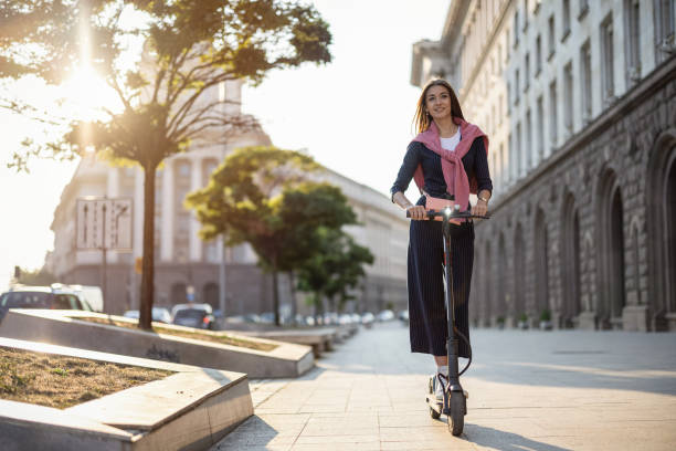 istock Well dressed woman riding e-scooter 1929883386