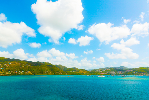 serene caribbean beach with lush green mountain