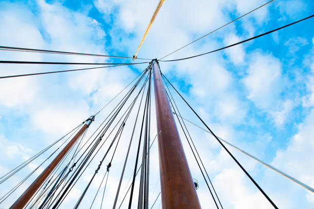 masts of sailing yachts without sails with anchoring ropes. view from below. - repairing sky luxury boat deck стоковые фото и изображения