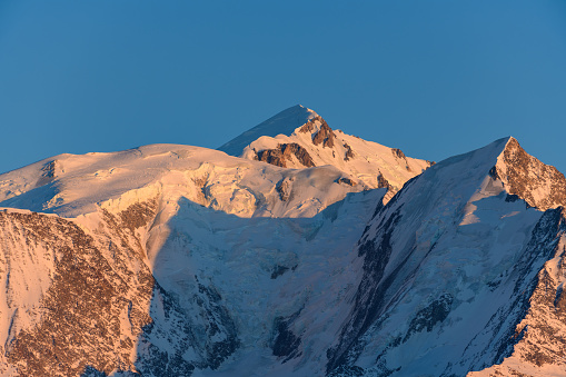 This landscape photo was taken in Europe, in France, Rhone Alpes, in Savoie, in the Alps, in winter. We see the summit of Mont Blanc at sunset.
