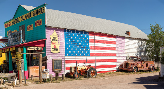 Seligman, USA - May 25, 2022: vintage historic souvenir shop at route 66 with stars and stripes painted at  facade as decoration in Seligman, USA.