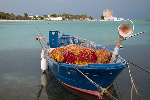 Old Wooden Fisherman's Boat Full of Colorful Fishing Nets. Sant'Isidoro, Lecce Procince, Salento, South Italy