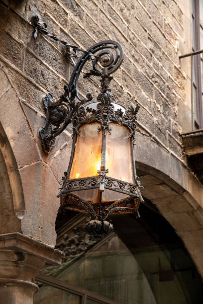 istock Historic wrought iron lantern with glass housing on an architecturally charming building 1929890957