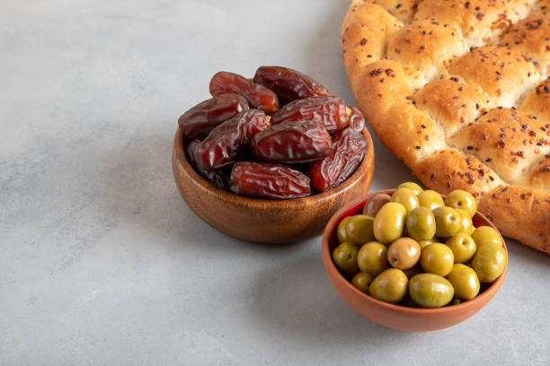 istock Traditional iftar meal with dates, pita bread, green olives 1929898971