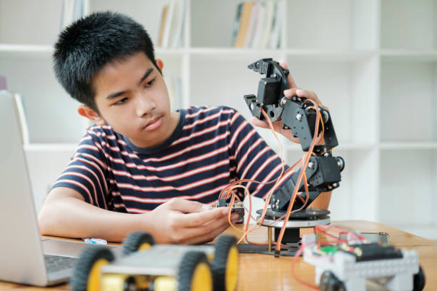 istock Asian teenager doing robot project in science classroom. technology of robotics programing and STEM education concept. 1929912261