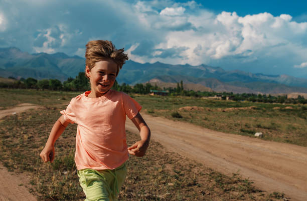 istock Happy boy running on mountains background 1929920486