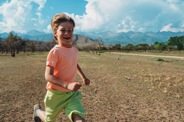 istock Happy boy running on mountains background 1929920497