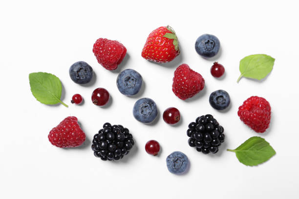istock Many different fresh berries and mint leaves on white background, flat lay 1929925056