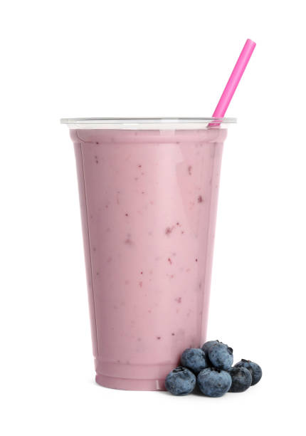 istock Plastic cup of tasty smoothie and fresh blueberries isolated on white 1929926038
