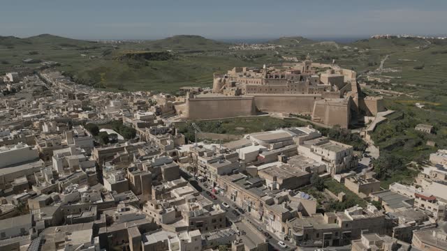 Aerial reveal shot of Victoria city surrounding Citadel, Gozo, Malta.