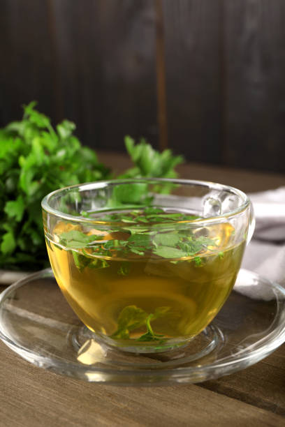 istock Aromatic herbal tea with parsley on wooden table, closeup 1929931687
