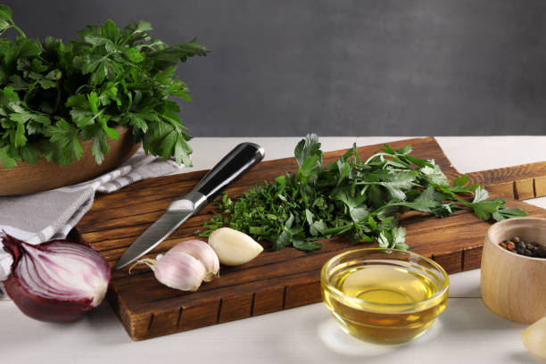 istock Fresh green parsley and different products on white wooden table 1929932211