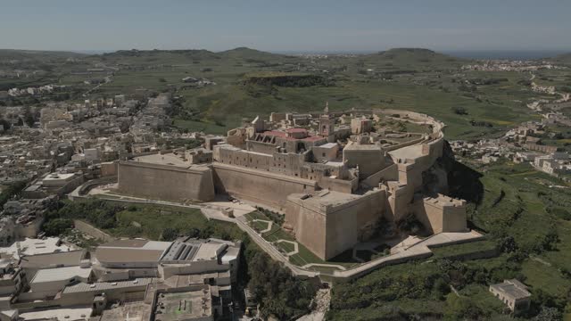 Orbiting aerial shot approaching the Citadel in the city of Victoria, Gozo, Malta.