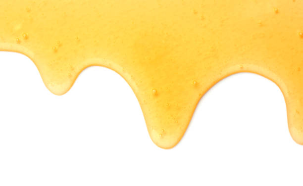 istock Tasty natural honey drips isolated on white, top view 1929939978