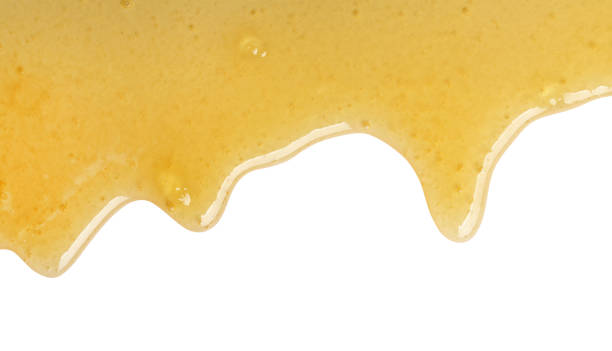 istock Tasty natural honey drips isolated on white, top view 1929940490