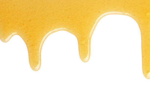 istock Tasty natural honey drips isolated on white, top view 1929940495
