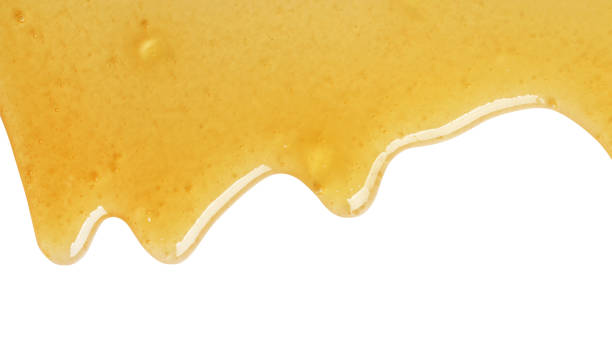 istock Tasty natural honey drips isolated on white, top view 1929940528