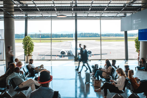 istock Diverse People Casually Waiting At Departures Terminal 1929952133