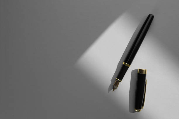 istock Stylish fountain pen on light grey textured table, top view. Space for text 1929953822
