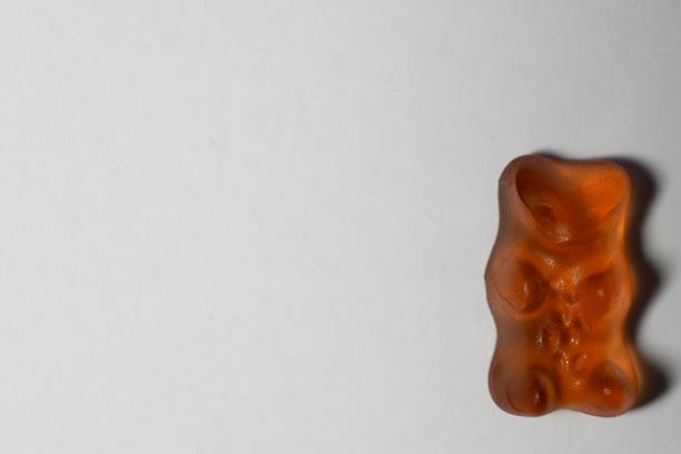 istock Orange gummy bear on white background 1929958900