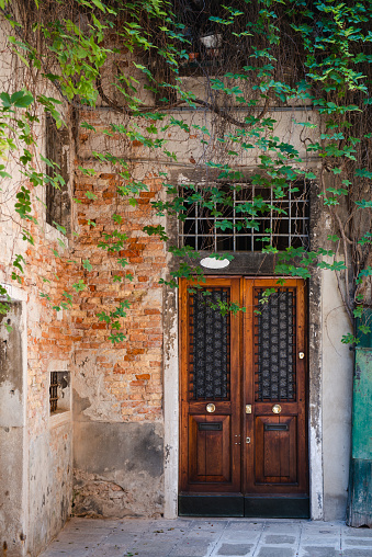 Front view of wooden door in an old Italian house.